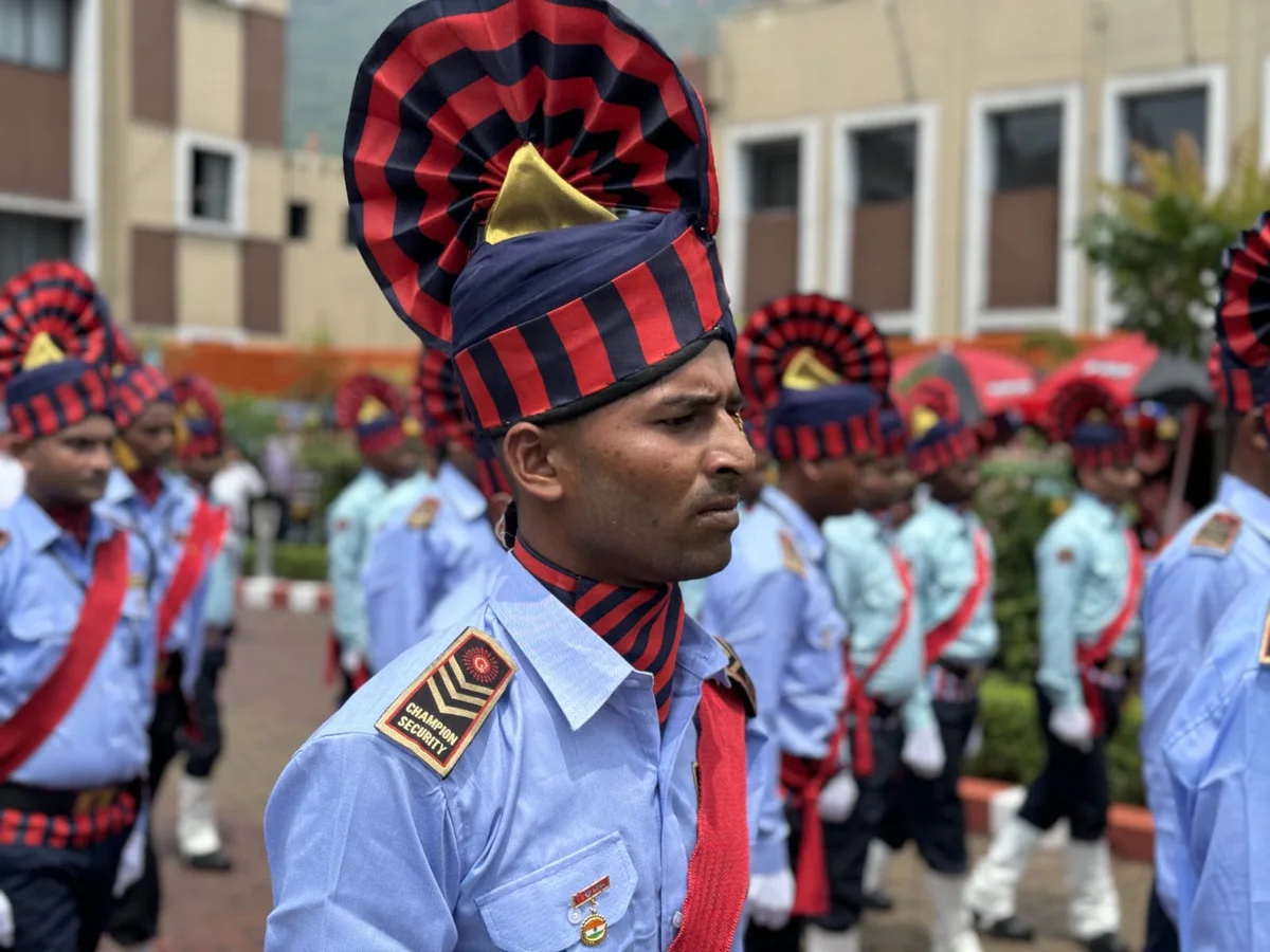 Uniformed security officer with personnel in parade formation